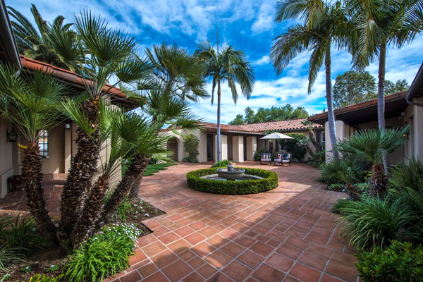 large patio with palm trees and bushes
